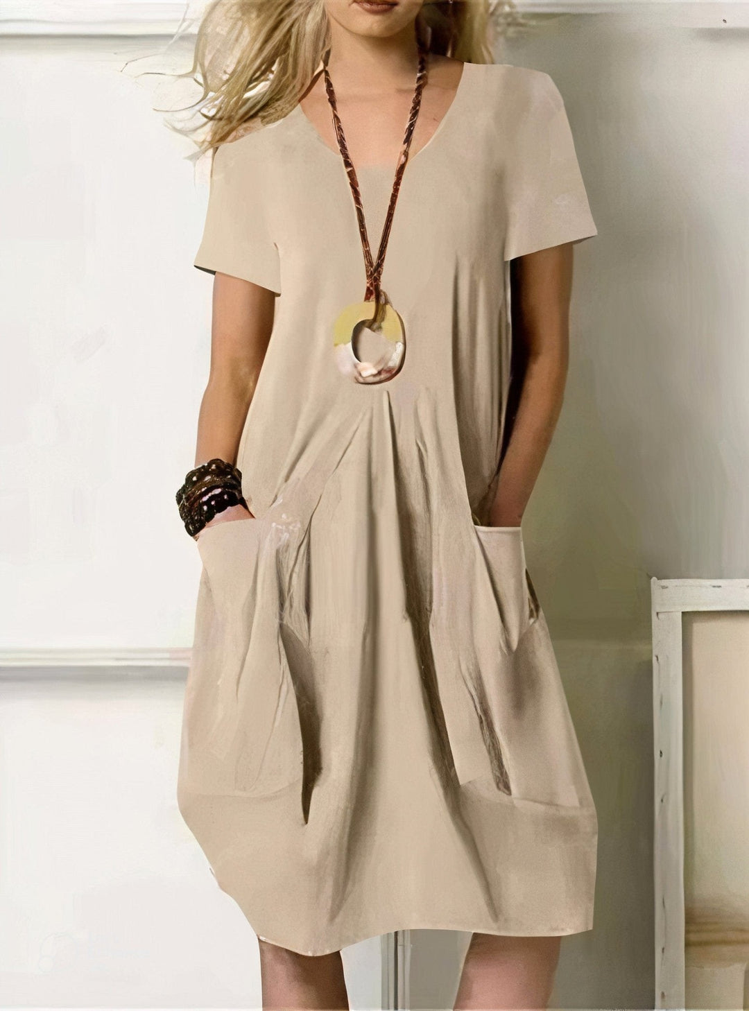 Woman wearing a relaxed cotton flow dress in soft coastal daylight, showing how color and easy shape work together after 60
